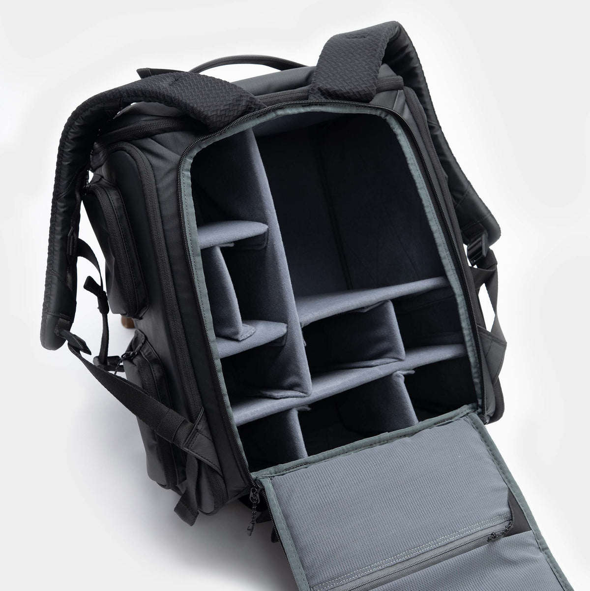 Black backpack with compartments on a white background