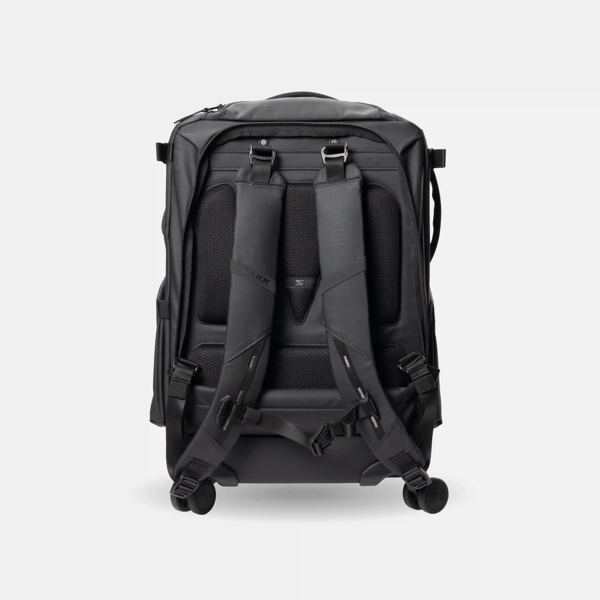 A black rolling backpack shown from the back, featuring padded shoulder straps, a mesh back panel, and dual spinner wheels, photographed on a light gray background.