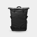 Black roll-top backpack on a light gray background