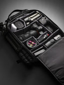 Camera bag with full loadout of camera equipment on a dark background