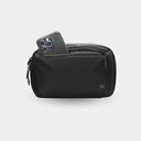 Black travel pouch with a phone inside on a white background