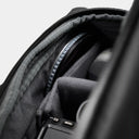 Camera equipment inside a backpack with a neutral background