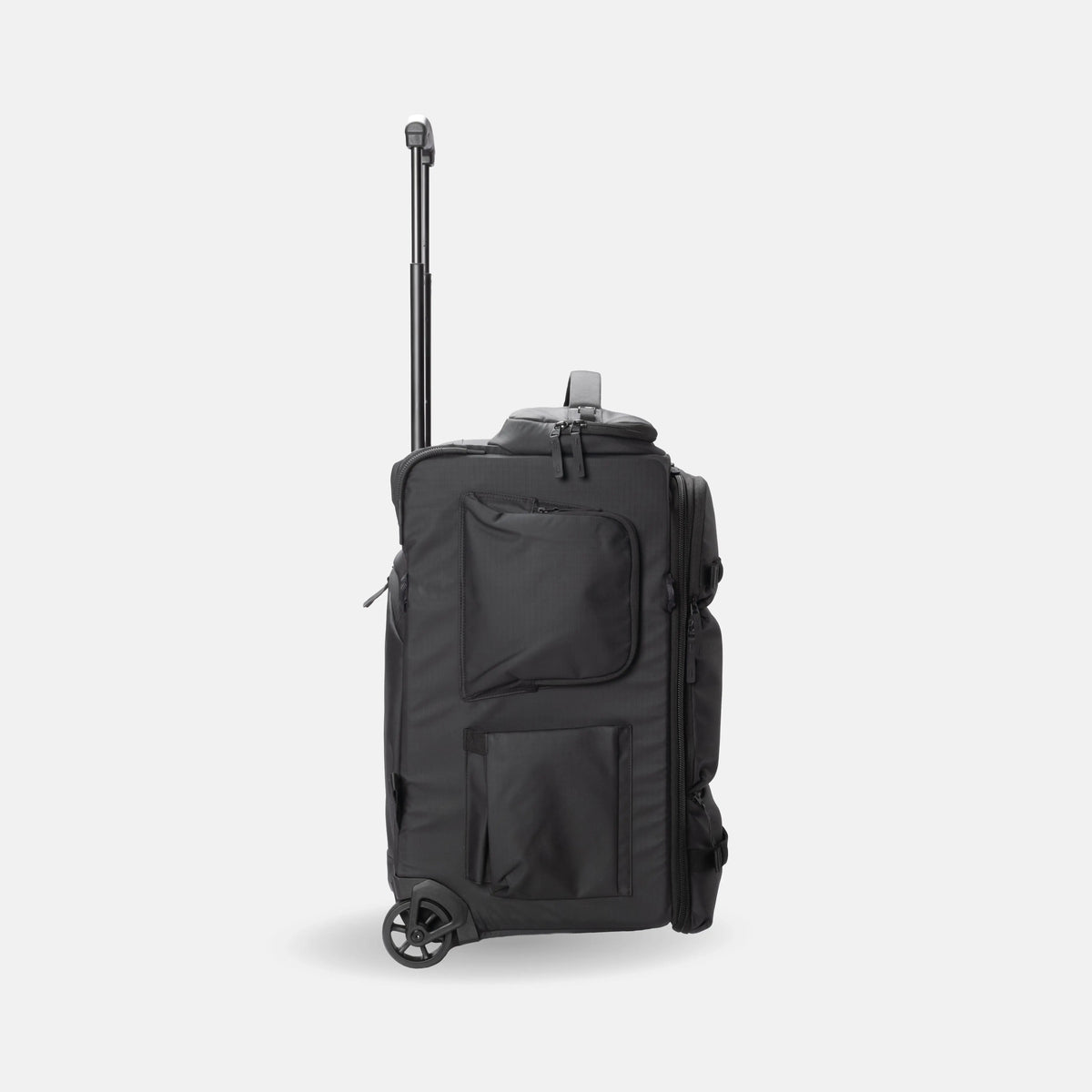 A black rolling duffel bag with an extended telescoping handle, shown from a three-quarter side view against a light gray background.