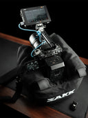 Camera with monitor on a black saddle bag against a dark background