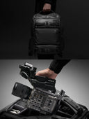 Black backpack with camera equipment on a gray background