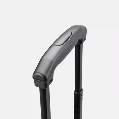 Close-up of a black telescoping suitcase handle with a textured grip and a small pull tab, set against a light gray background.