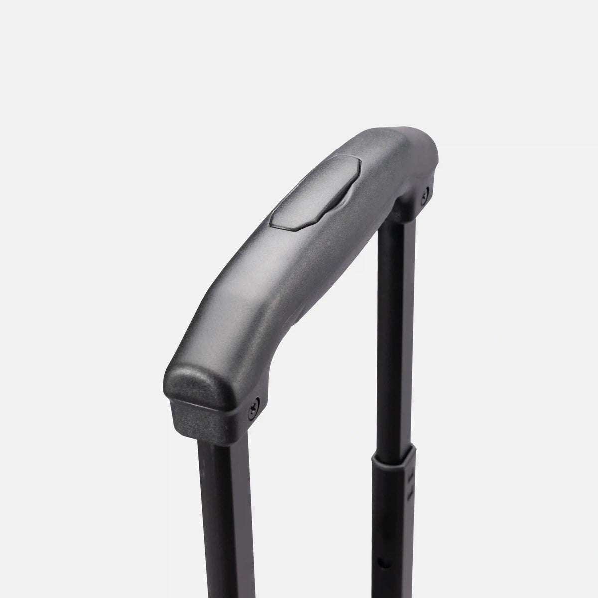 Close-up of a black telescoping suitcase handle with a textured grip and a small pull tab, set against a light gray background.