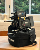 Versatile camera saddle for location work, set on rocks, car hoods, or flat ground.