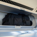 Sakk Pack V2 stored in airplane overhead cabin. Fits cinema cameras, laptop, and travel essentials.