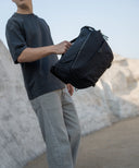 Travel photographer using Nomad sling bag. Lightweight and waterproof design keeps gear safe and organized.